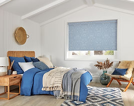 Image of a roller blind in louvolite fabric Florence Persian Blue in a master bedroom.