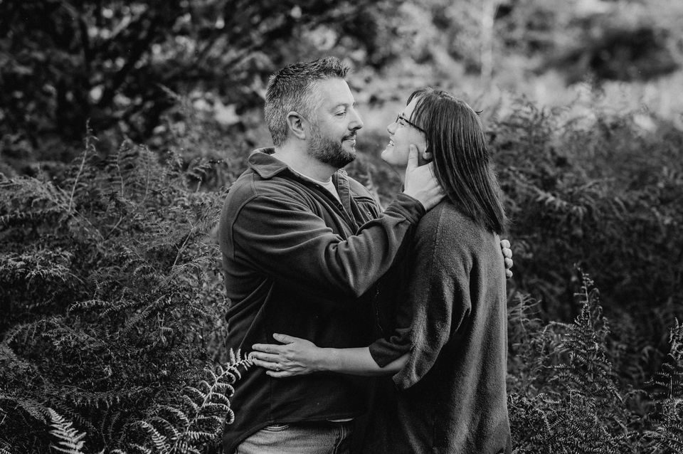 black and white photo of couple hugging and looking at each other on the Quantock Hills.