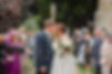 Bride and groom kissing in a confetti tunnel at St Andrew's Church, Trent, Dorset.