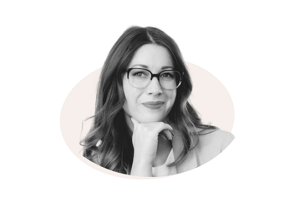 Emilee Williams with glasses poses and smiles warmly.