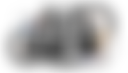 Several women are happily posing for the camera, all smiling and enjoying the moment together.