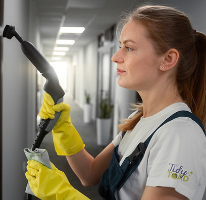 Woman cleaning indoors representing Studio of Grace graphic design work for service industry clients