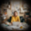 Woman sitting at a messy desk