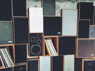 Collection of loudspeaker cabinets arranged against a wall