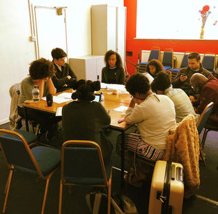 Jaz sits around a table with various actors, for a table read of webseries Dead Ends.