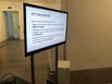 A modern television on a stand showcases a presentation slide. The title reads: IYP's Involvement?