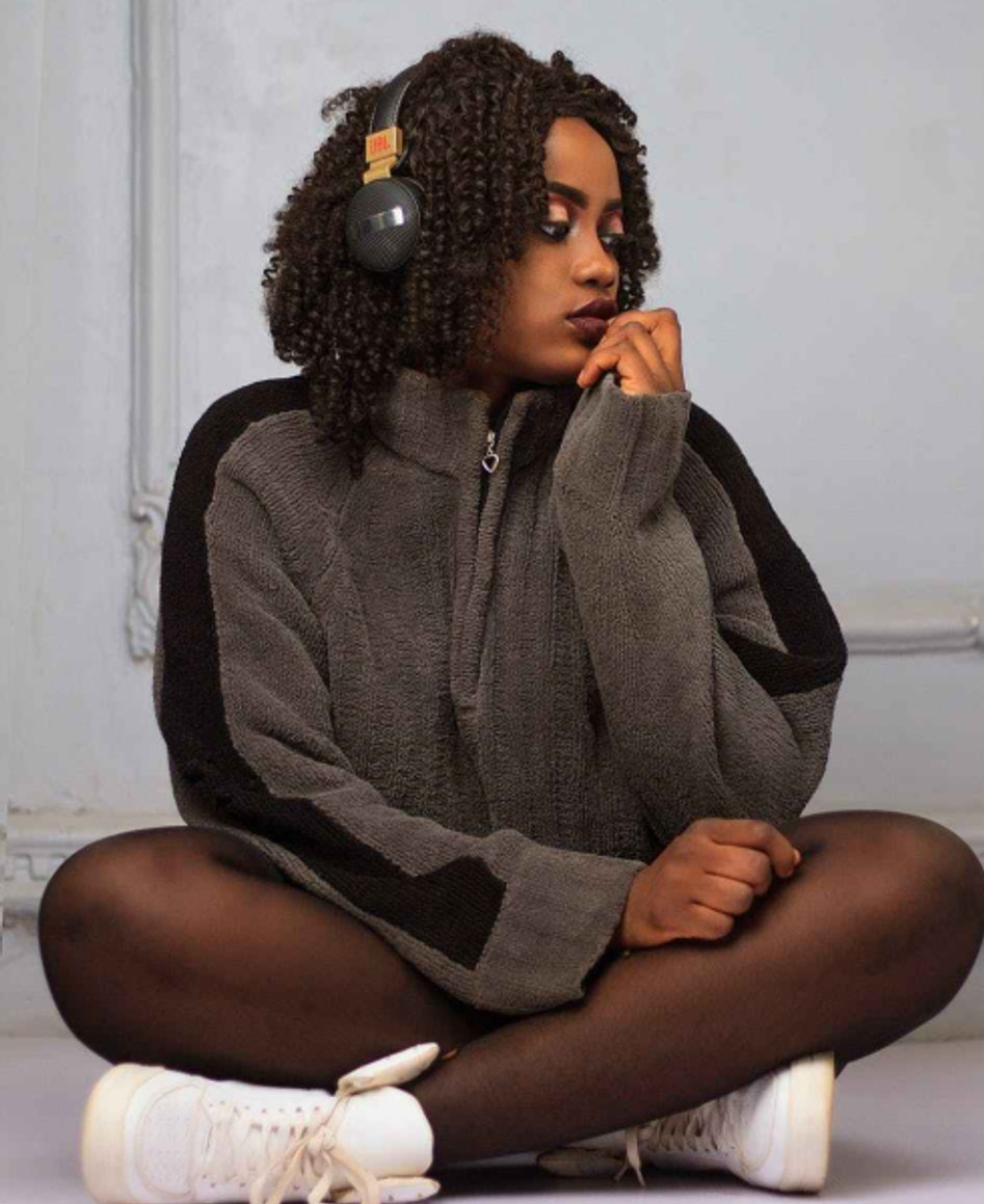 woman sitting in front of white wall