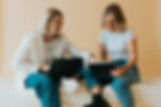 Image of Dr. Caitlin Sembach working with her assistant, Christy. They are working on a laptop and a tablet.