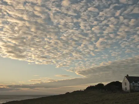 rippling clouds float across a sunset sky