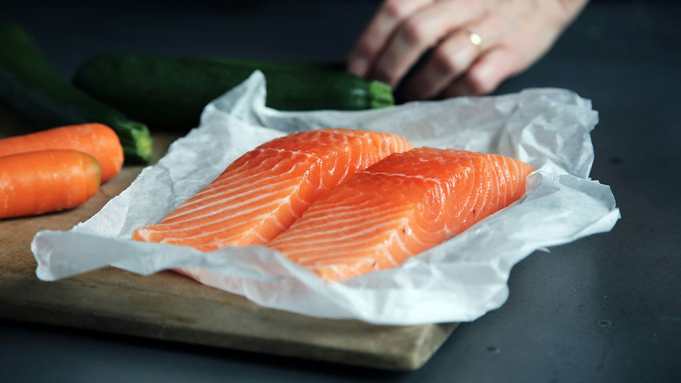After reading about what to eat to get pregnant faster, a woman is preparing some salmon for lunch to boost her fertility.