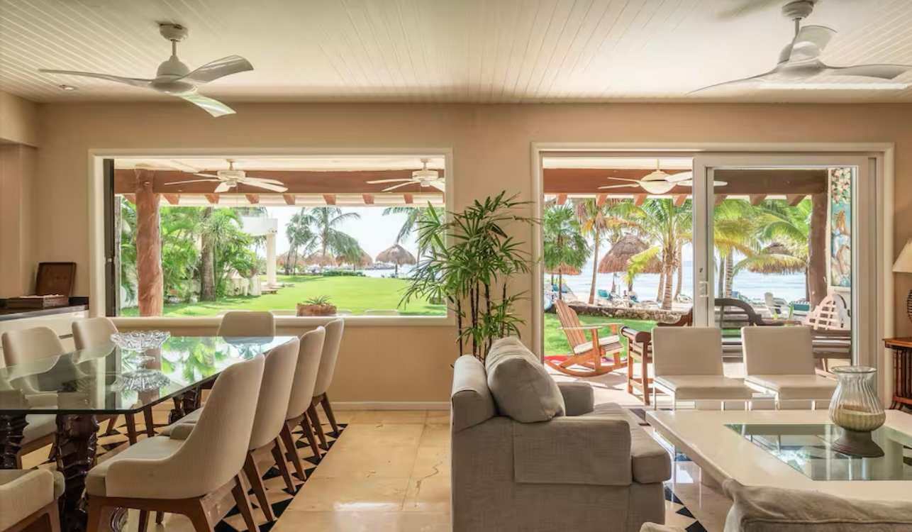 Living and dining room opening onto the lawn and the beach