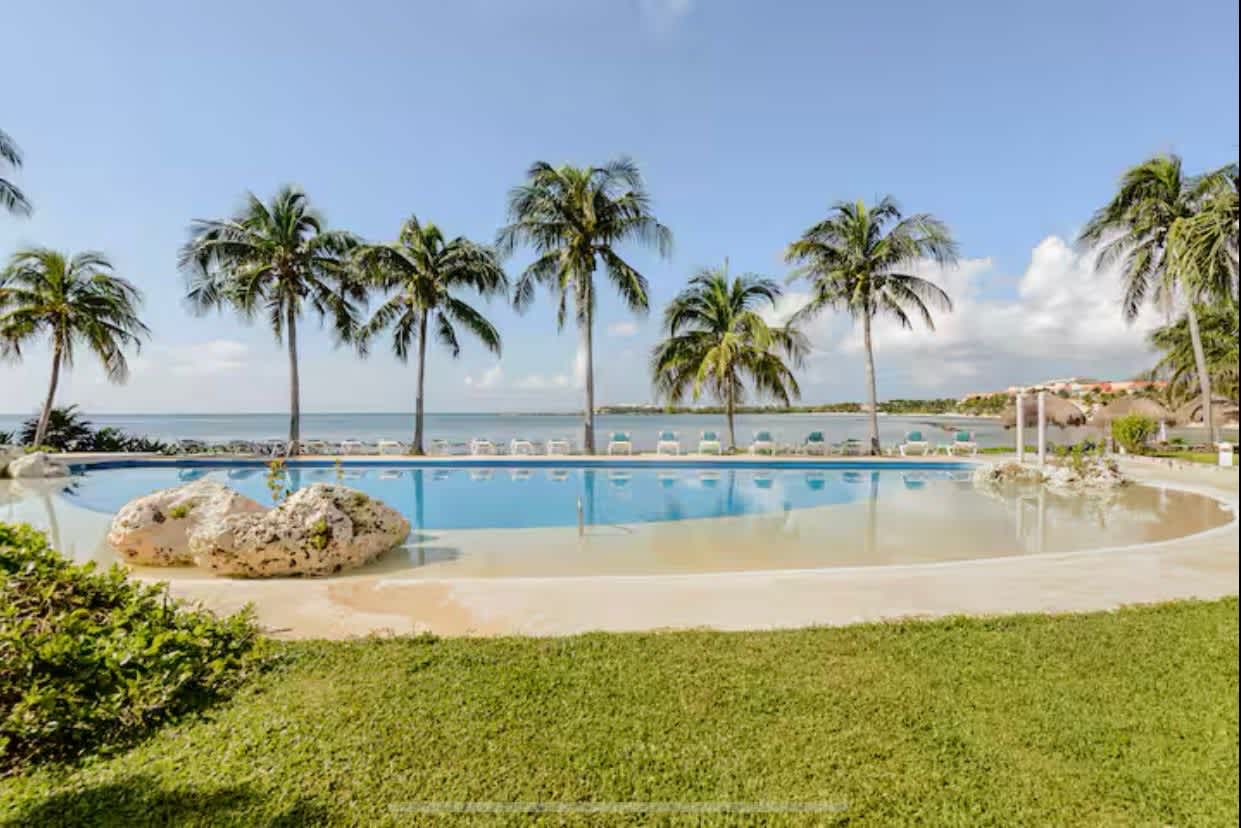 Beachfront pool and lawn facing the sea