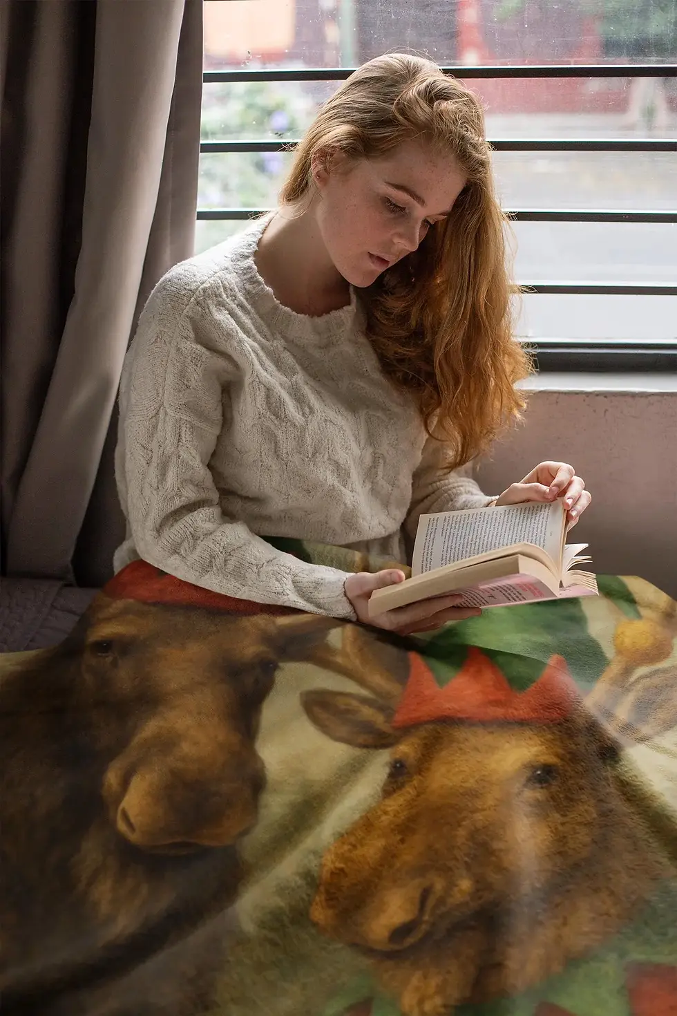 Two moose wearing festive elf hats in a soft painterly style, featured on a cozy holiday velveteen blanket