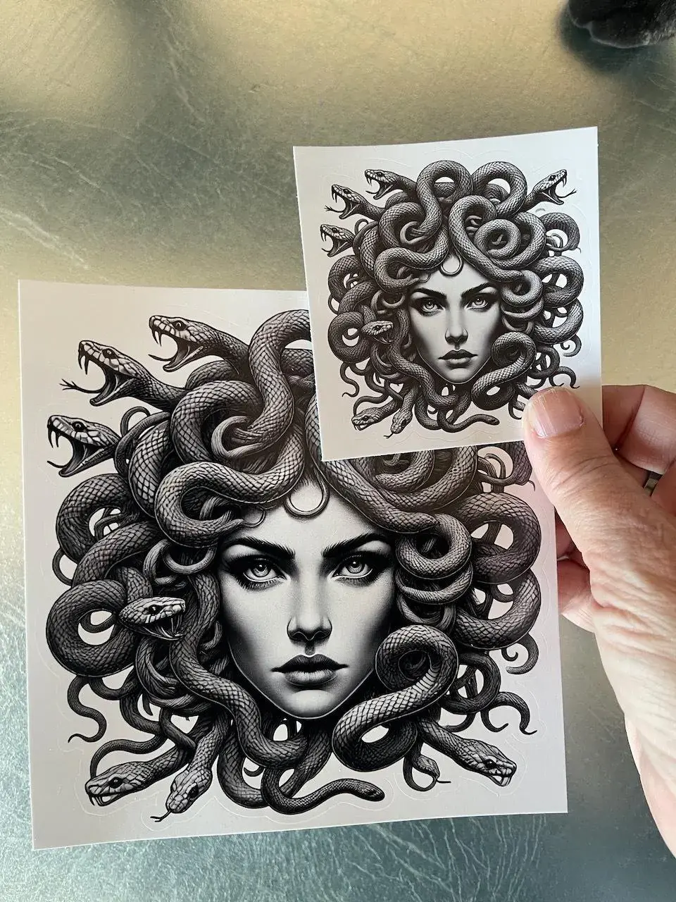 Medusa vinyl sticker with bold black linework, detailed snakes, and a fierce gaze on a white background.