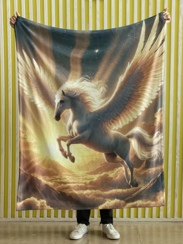 Velveteen blanket featuring a white winged Pegasus flying through golden clouds with radiant sunset light in the background.