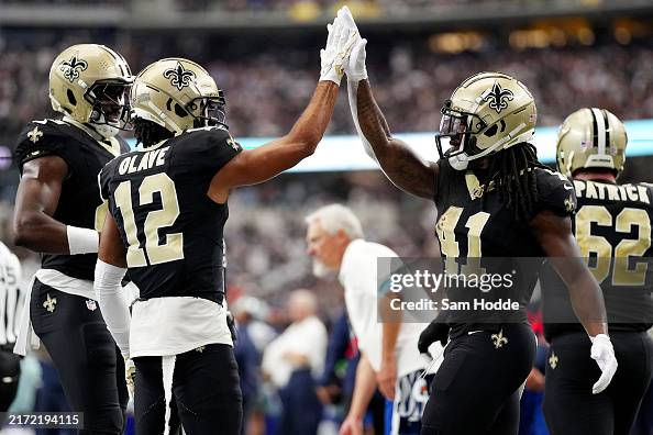 ARLINGTON, TEXAS - SEPTEMBER 15: Alvin Kamara #41 and Chris Olave #12 of the New Orleans Saints celebrate a touchdown during the second quarter at AT&T Stadium on September 15, 2024 in Arlington, Texas. (Photo by Sam Hodde/Getty Images)