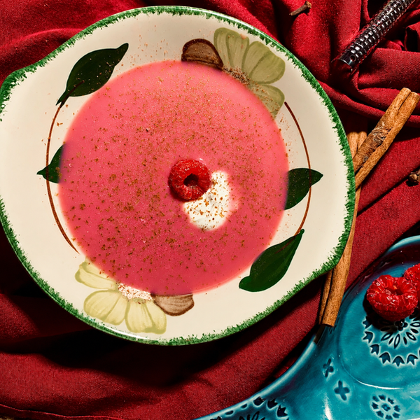 Luscious raspberry soup served chilled, topped with a dollop of crème fraîche and freshly grated cinnamon