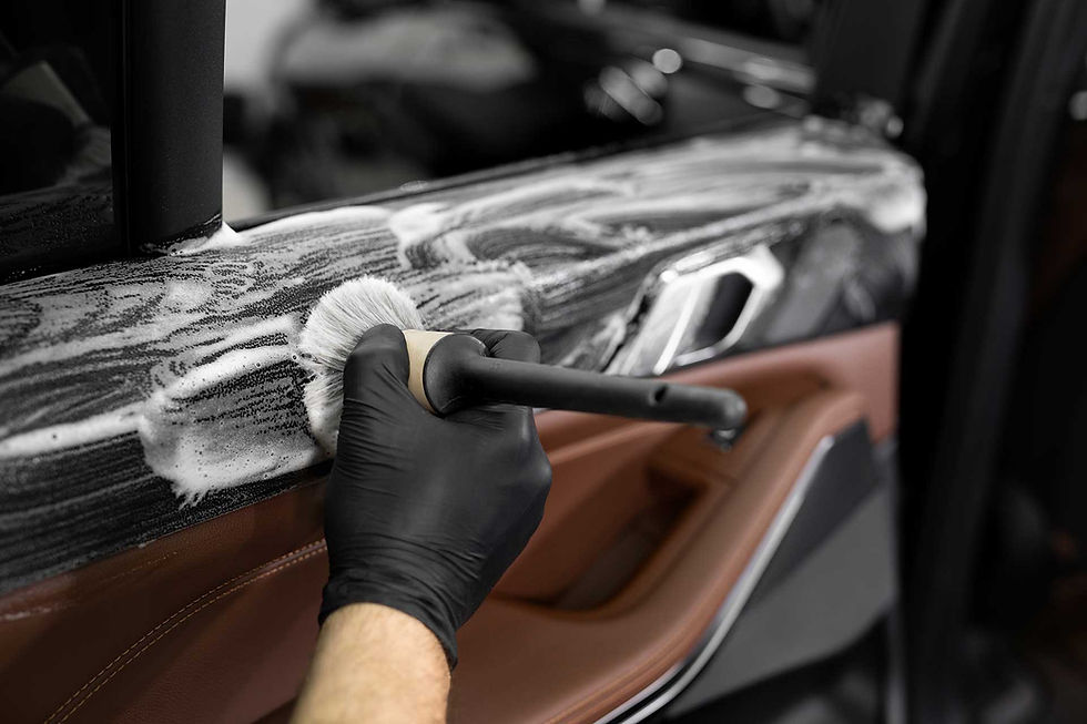 Professional car interior detailing with foam and brush
