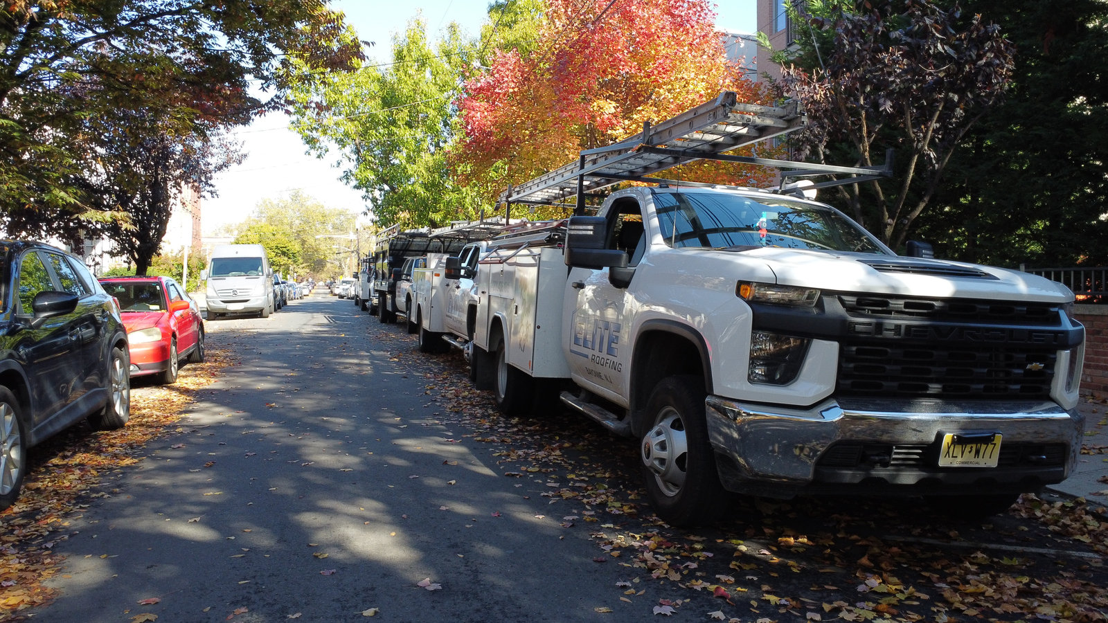 Elite Roofing trucks in fall scenery