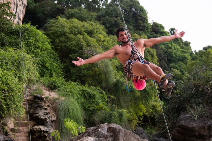 Man ziplining with arms outstretched. Portrait by Dafna Talmon