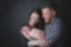 Newborn session parent pose on grey