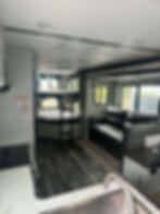Keystone Bullet 290BHS interior with sofa, kitchen, and bunk beds