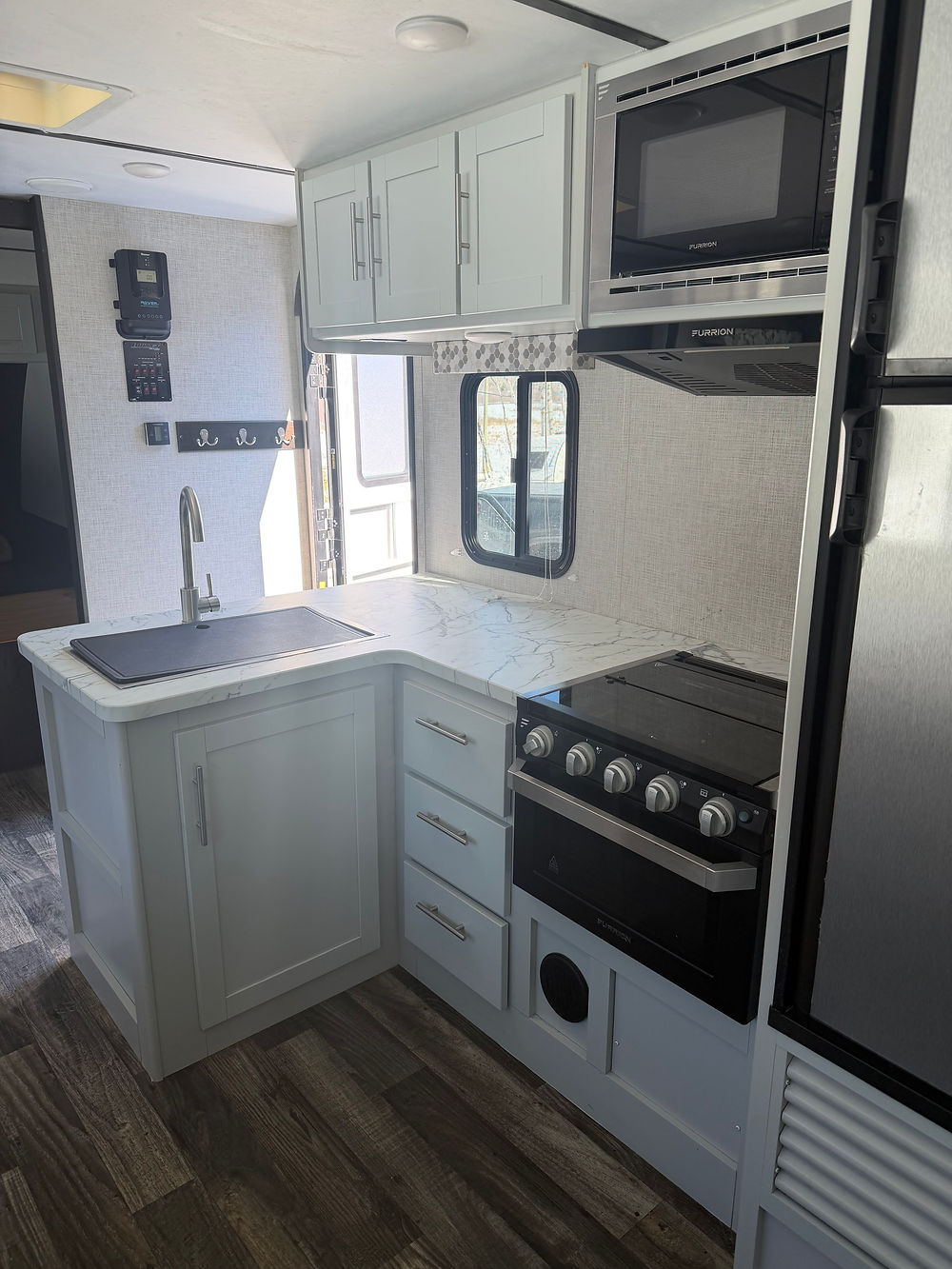 Keystone Bullet 290BHS kitchen with light cabinets, sink, and stove