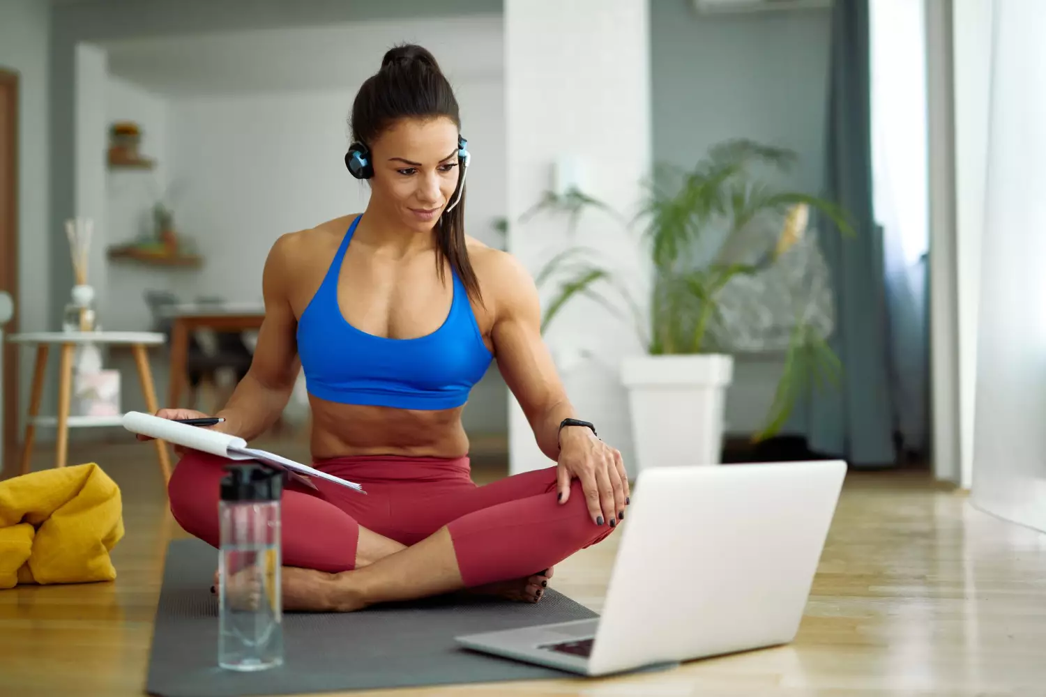 female-fitness-instructor-having-online-consultations-while-using-computer-in-the-living-r