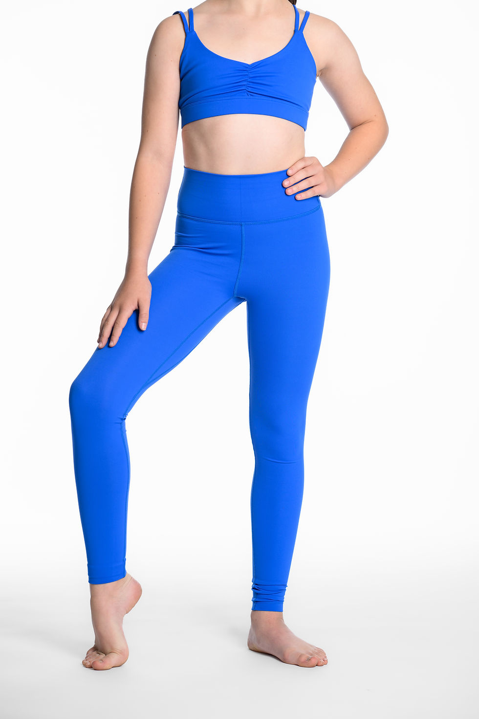 High-waisted, Full-length Bright Blue Sleek Leggings that fit snugly and stretch smoothly along her legs