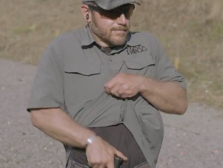 Pictured is Rick Hogg founder of War HOGG Tactical demonstrating drawing from appendix concealed carry draw