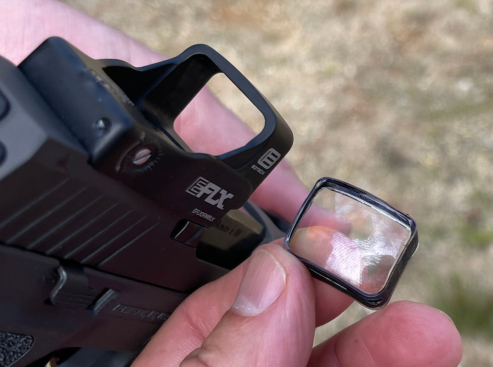 an open emitter red dot sight with a lens popped out, this optic is ineffective