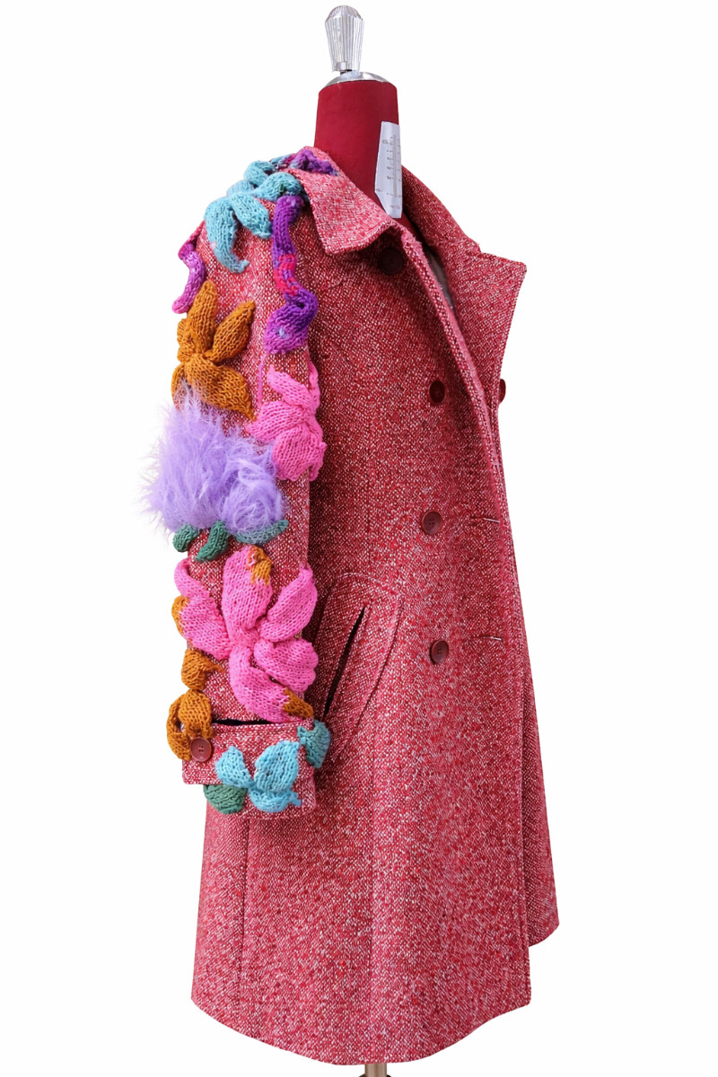 Thumbnail: Side view from one off DURGA coat made from vintage orange coat and preloved wool hand knitted and hand sewn flowers, snakes