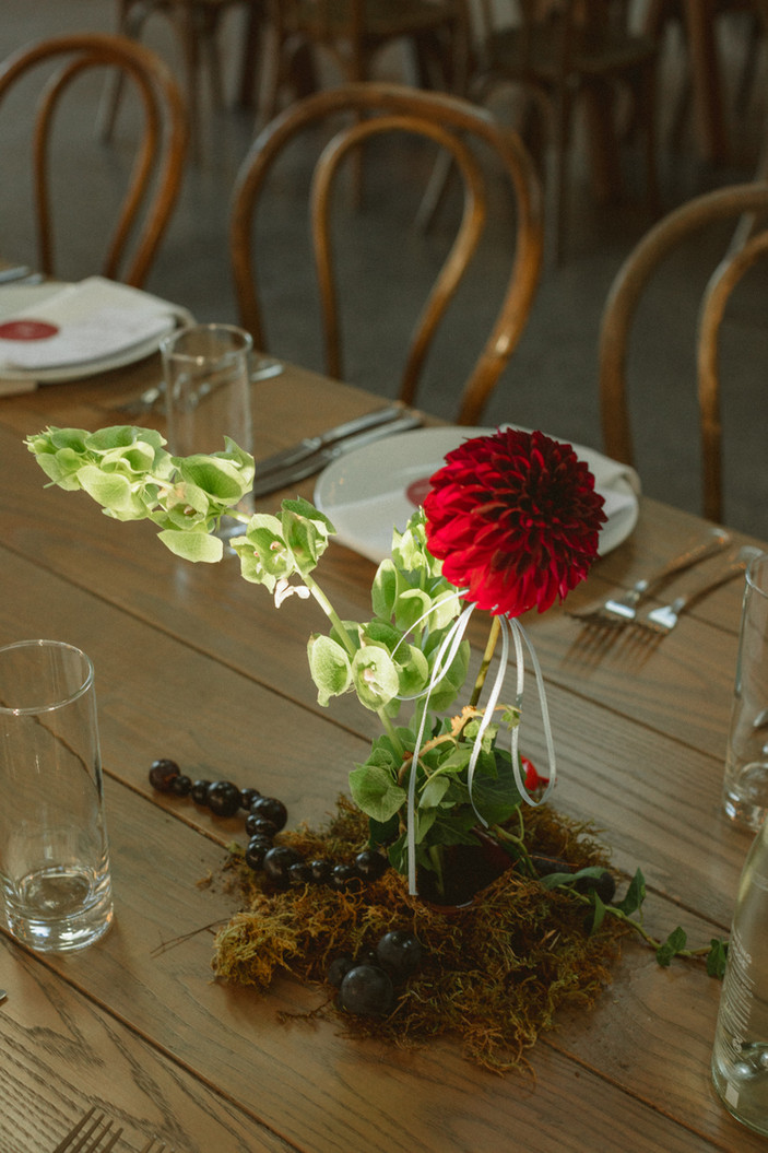 modern red and green sculptural wedding table florals with grapes