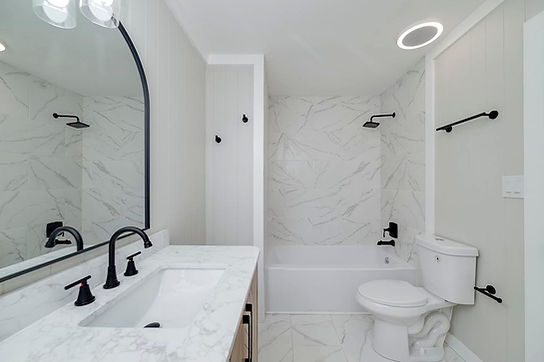Modern bathroom remodel: white marble, black fixtures