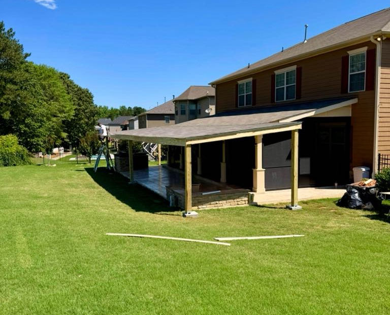 Covered patio addition extending from house