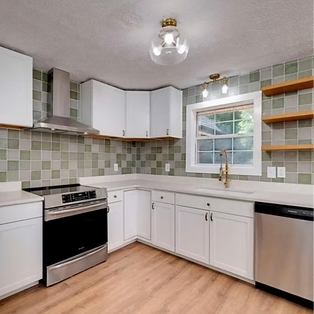 Modern white kitchen remodel with stainless steel appliances