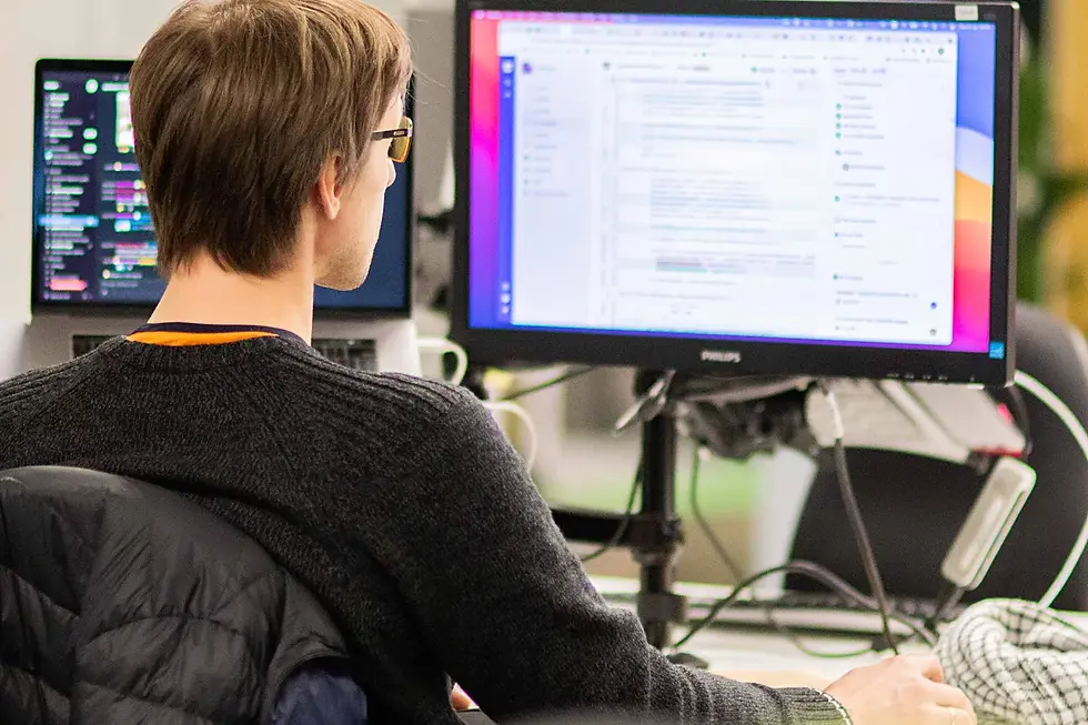 Person working at computer, with code on their screen.