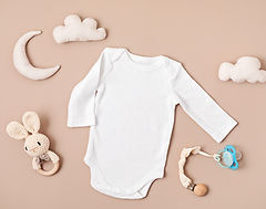 Flat lay with baby sleep accessories with pacifier, pajamas and toys. Newborn sleeping rul
