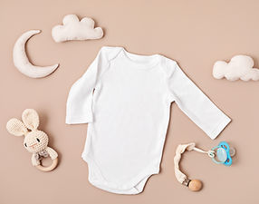 Flat lay with baby sleep accessories with pacifier, pajamas and toys. Newborn sleeping rul