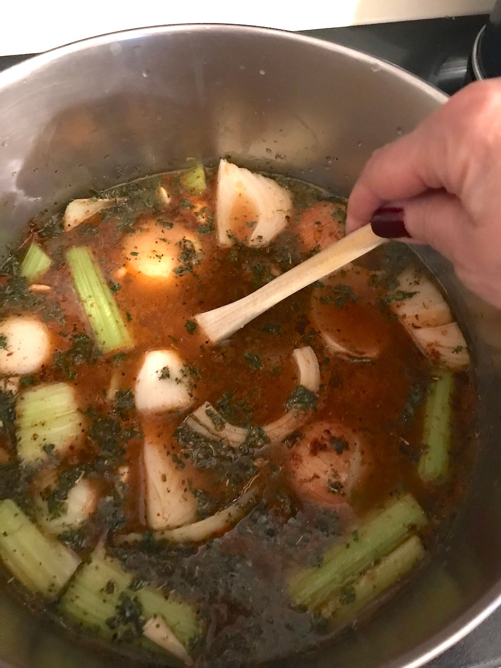 Celery, onions and carrots in beef soup.