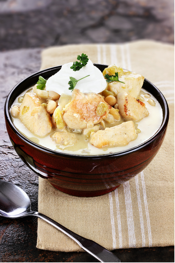 chili with white chicken meat with northern beans topped with sour cream