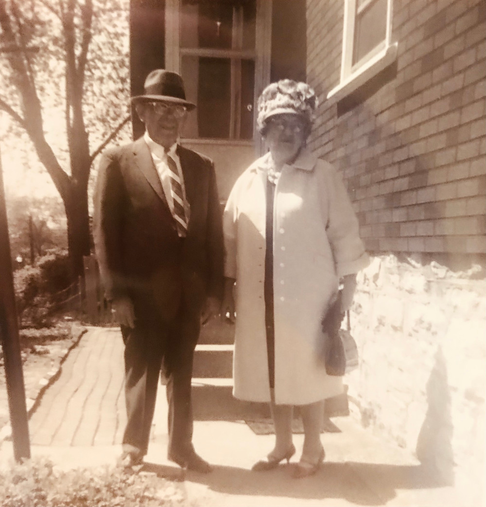 Elderly man and woman dressed for church.