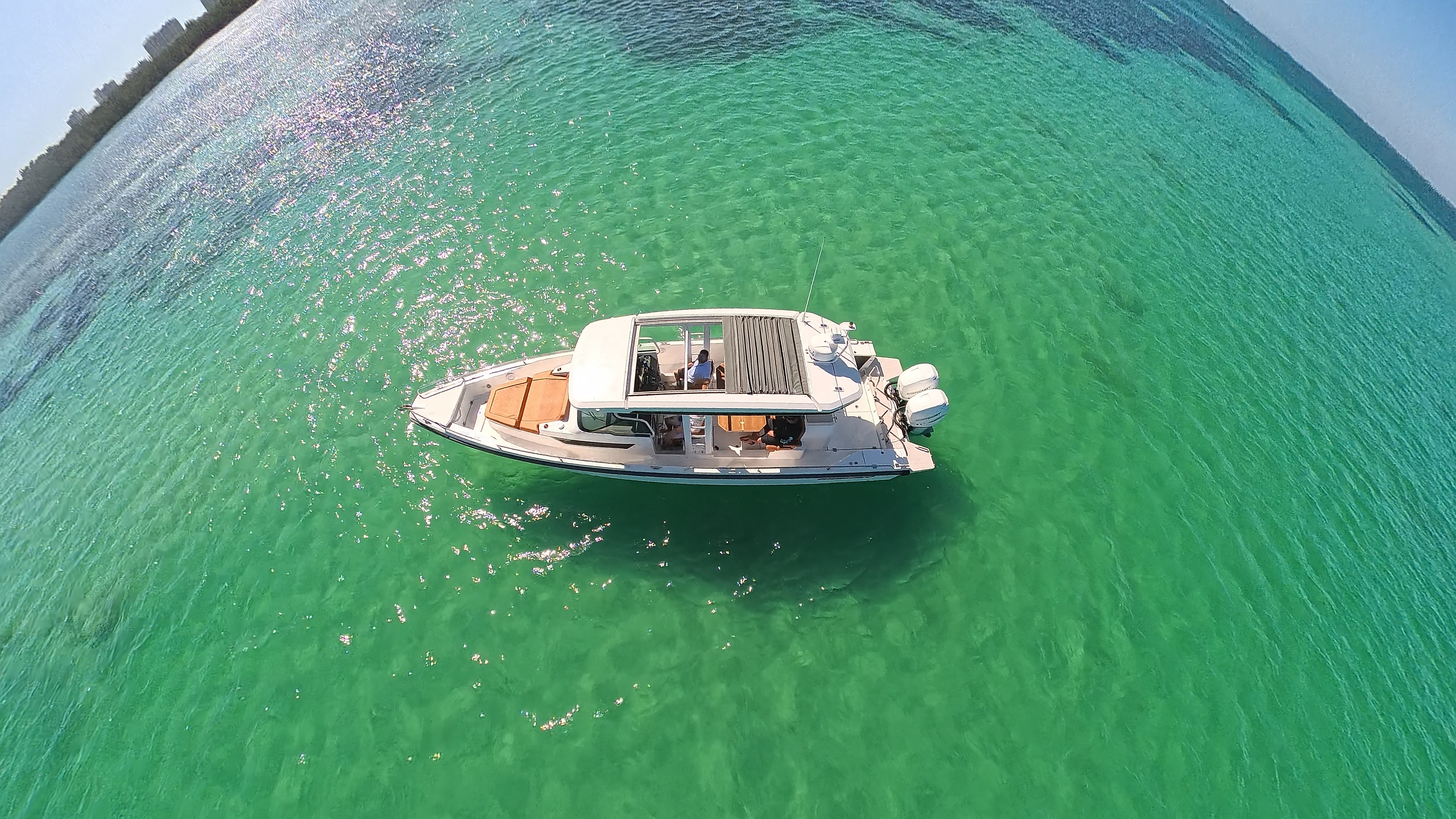The Axopar anchored in clear Gulf water