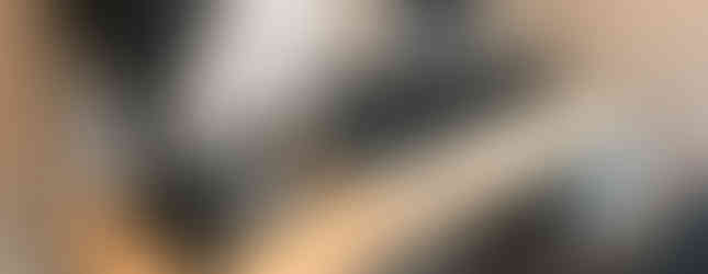 Studio desk with rack units built in on steel legs in a room with speakers on stands