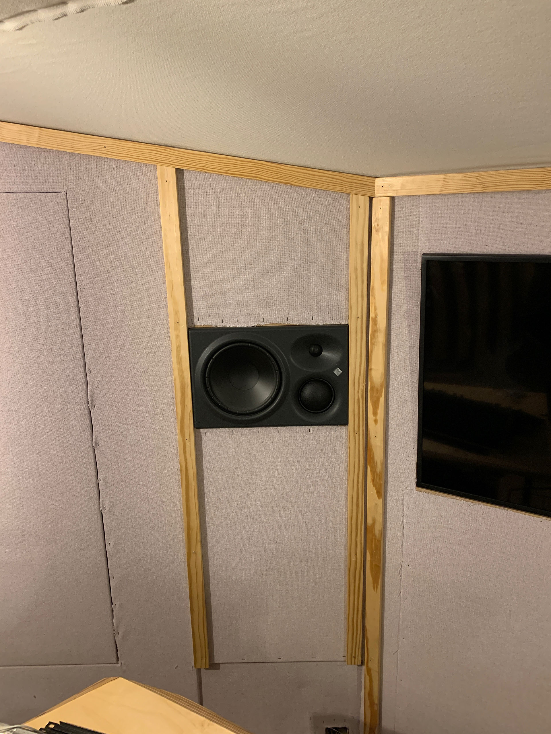 Wood panelling around a speaker and TV