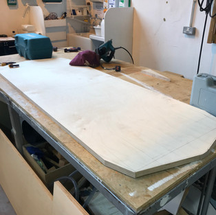 plywood sheet cut to shape on work bench