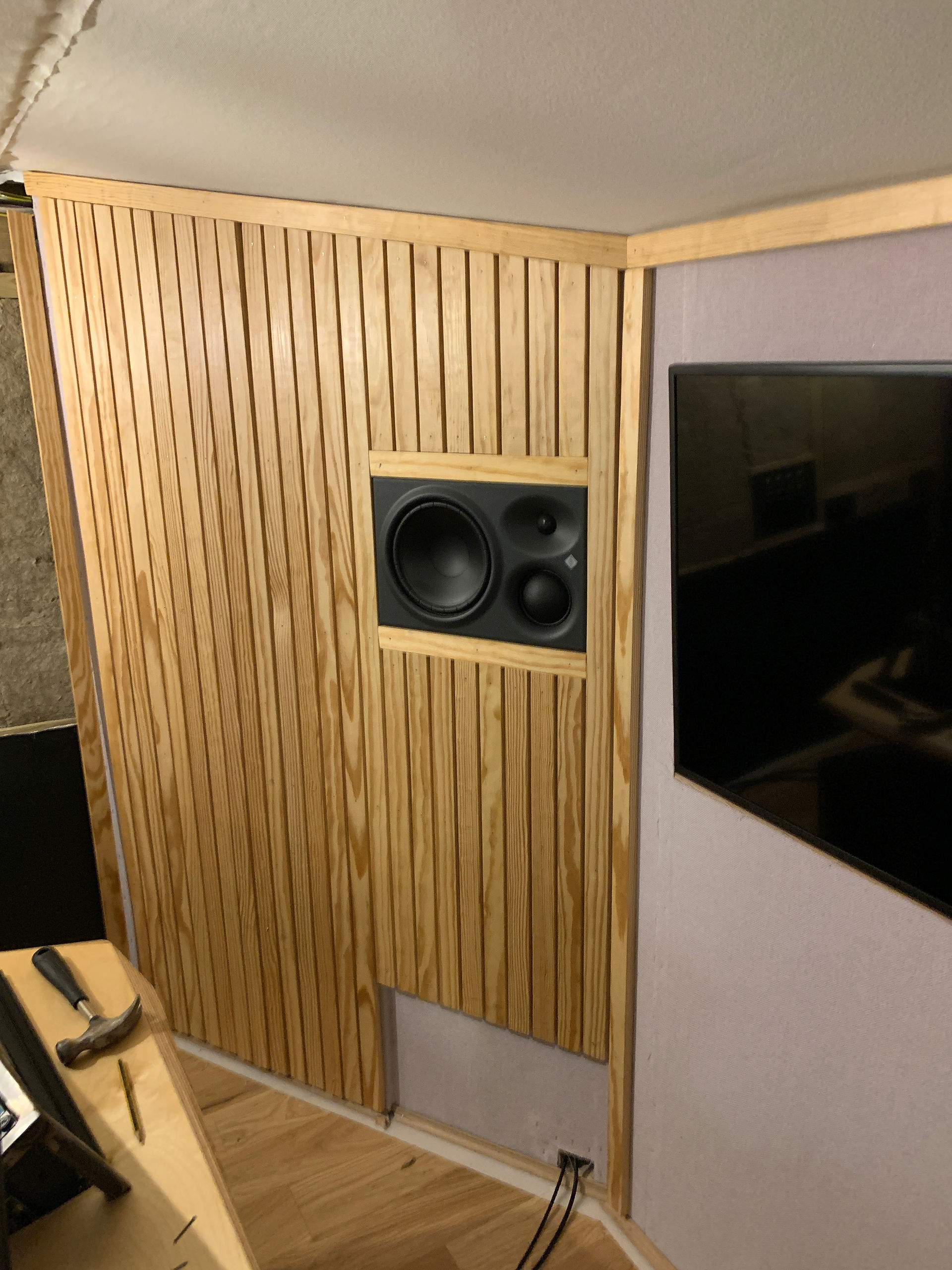 Wood panelling around a speaker and TV
