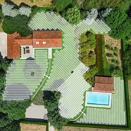 Aerial view of a property with a pool, manicured lawns, and organized gardens.