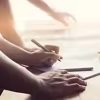 Close-up view of a professional hand while writing something on paper