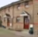 A house with a composite front door and visible gutter systems